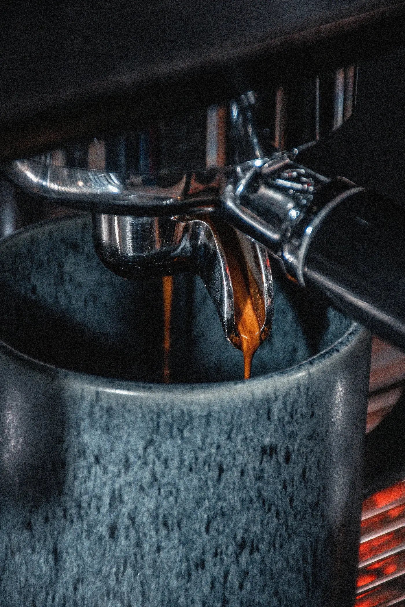 Espresso being poured into a dark blue mug from an espresso machine. - Repair service by Better Brands
