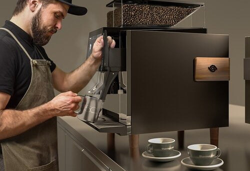 Barista steaming milk with Black&White4 Competizione Thermoplan espresso machine for Commercial Cafes + Restaurants